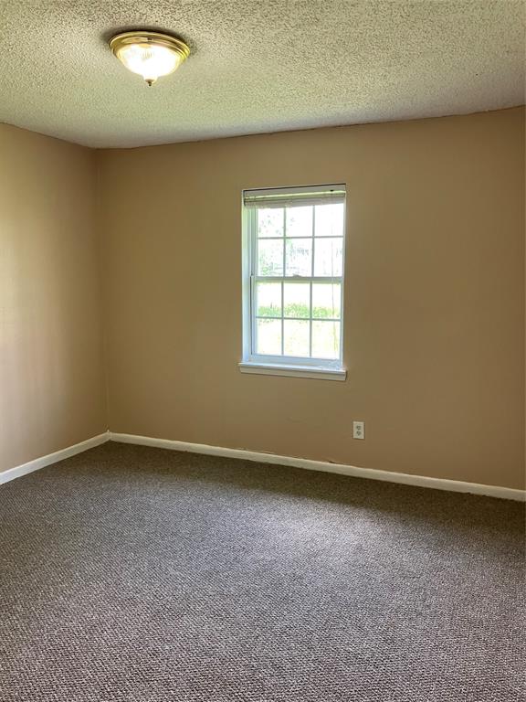 717 Bluebonnet Street Mexia, TX 76667 - Photo 21 of 25 an empty room with a empty space and a window