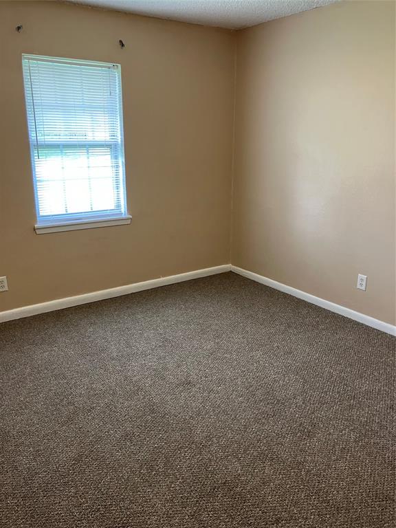 717 Bluebonnet Street Mexia, TX 76667 - Photo 22 of 25 an empty room with a window
