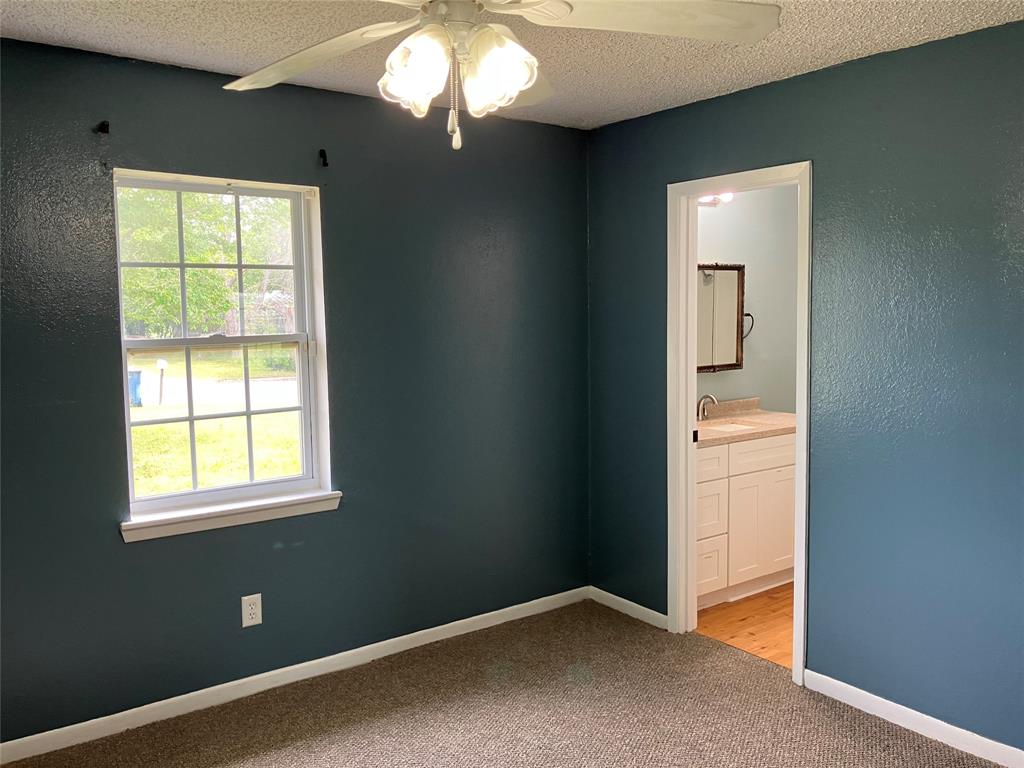 717 Bluebonnet Street Mexia, TX 76667 - Photo 23 of 25 an empty room with windows and closet