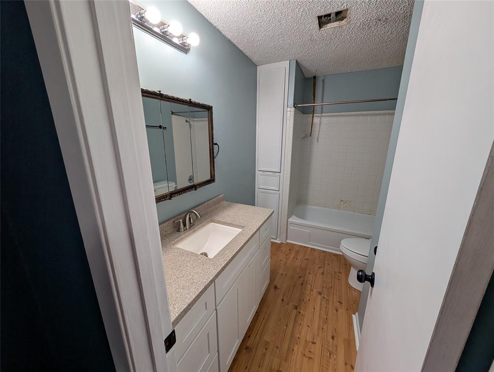 717 Bluebonnet Street Mexia, TX 76667 - Photo 25 of 25 a bathroom with a sink a mirror and a shower