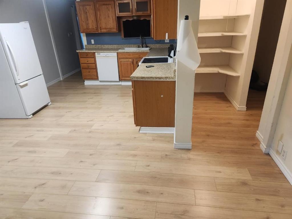 717 Bluebonnet Street Mexia, TX 76667 - Photo 9 of 25 a view of kitchen and wooden floor