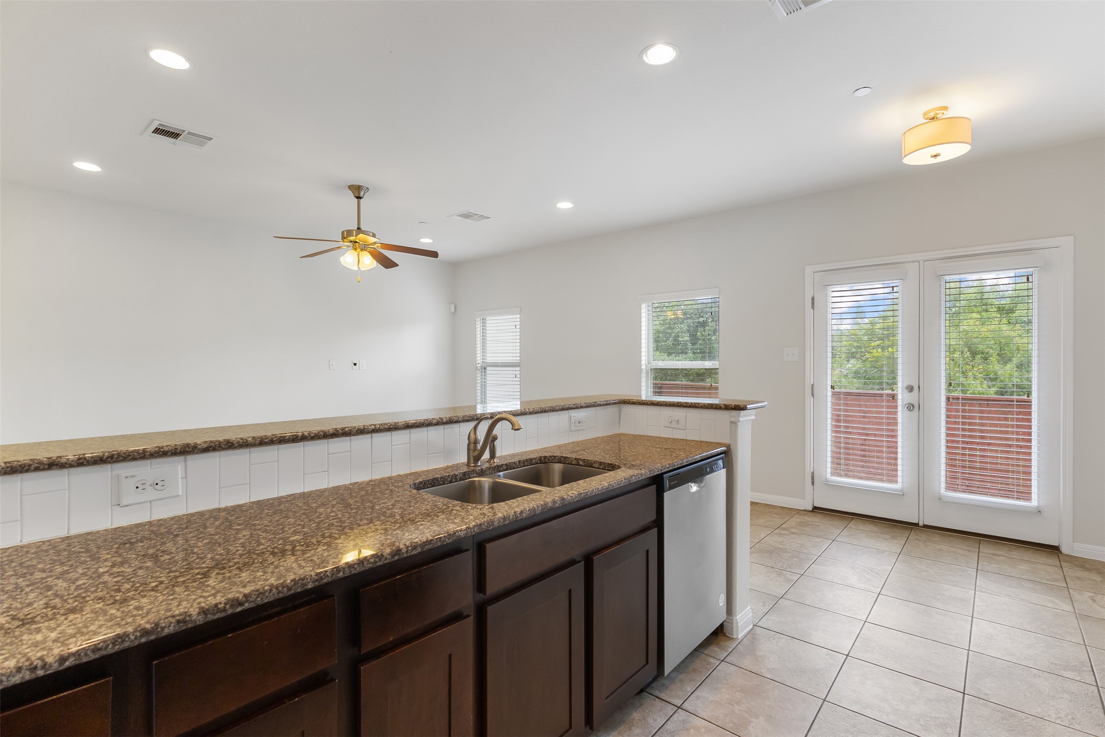 1510 Catalan Road, Unit 602 Austin, TX 78748 - Photo 13 of 36 Kitchen with dishwasher, healthy amount of natural light, dark brown cabinets, and recessed lighting