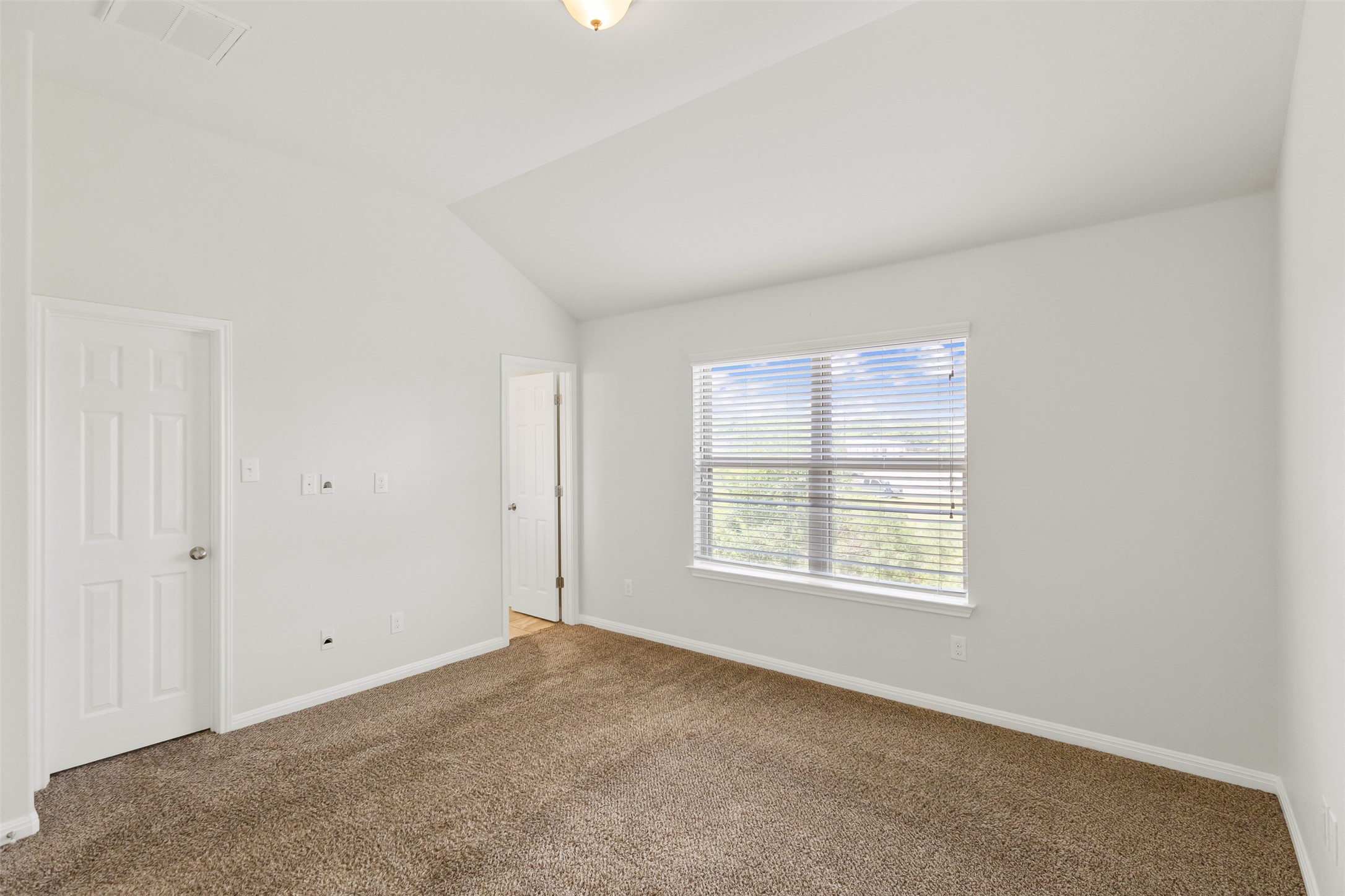 1510 Catalan Road, Unit 602 Austin, TX 78748 - Photo 18 of 36 Carpeted empty room with baseboards and vaulted ceiling