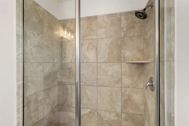 a bathroom with a glass shower door