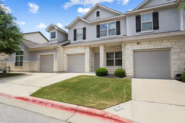 a front view of a house with garage and porch