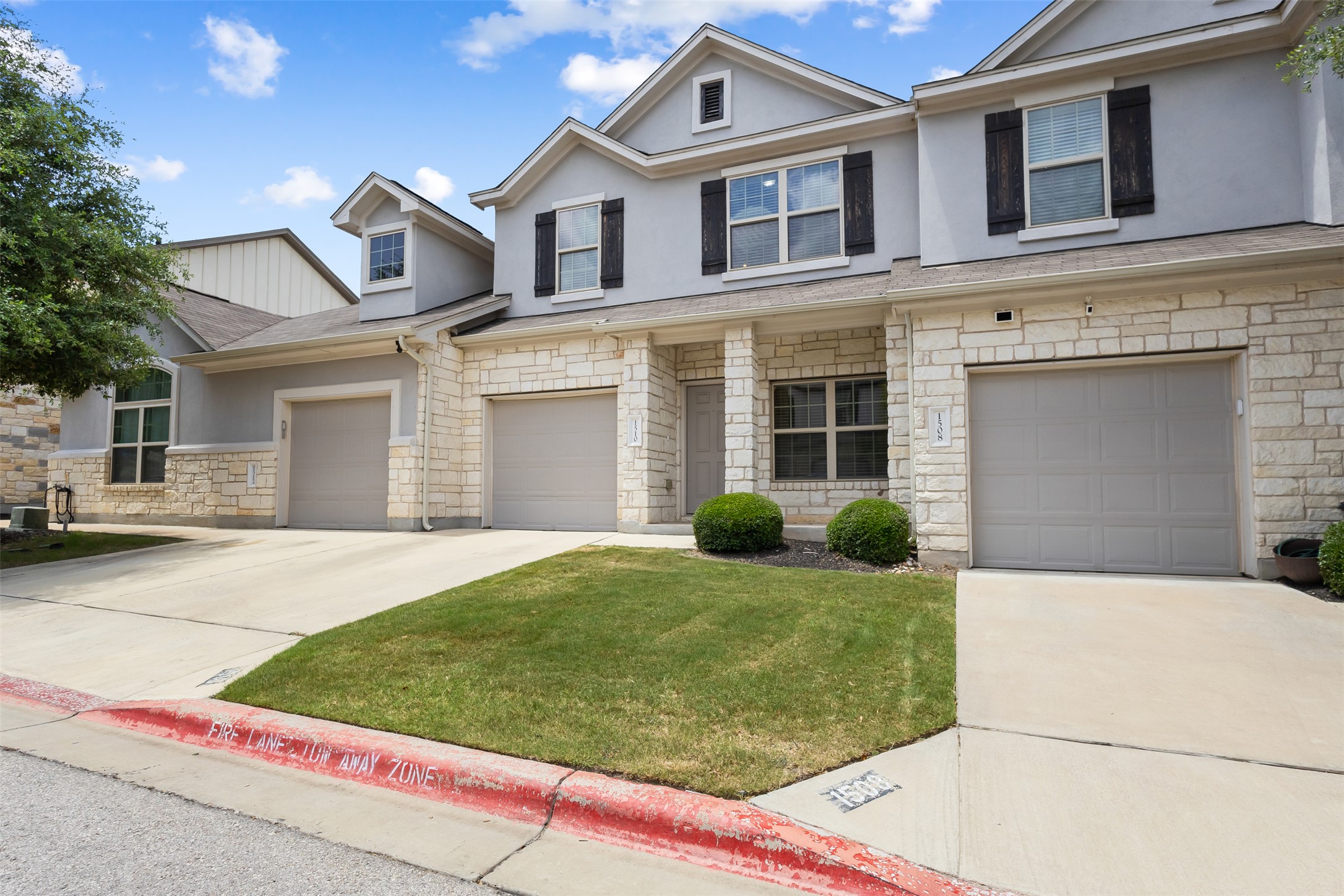 1510 Catalan Road, Unit 602 Austin, TX 78748 - Photo 2 of 36 View of front facade with stone siding, stucco siding, concrete driveway, and an attached garage