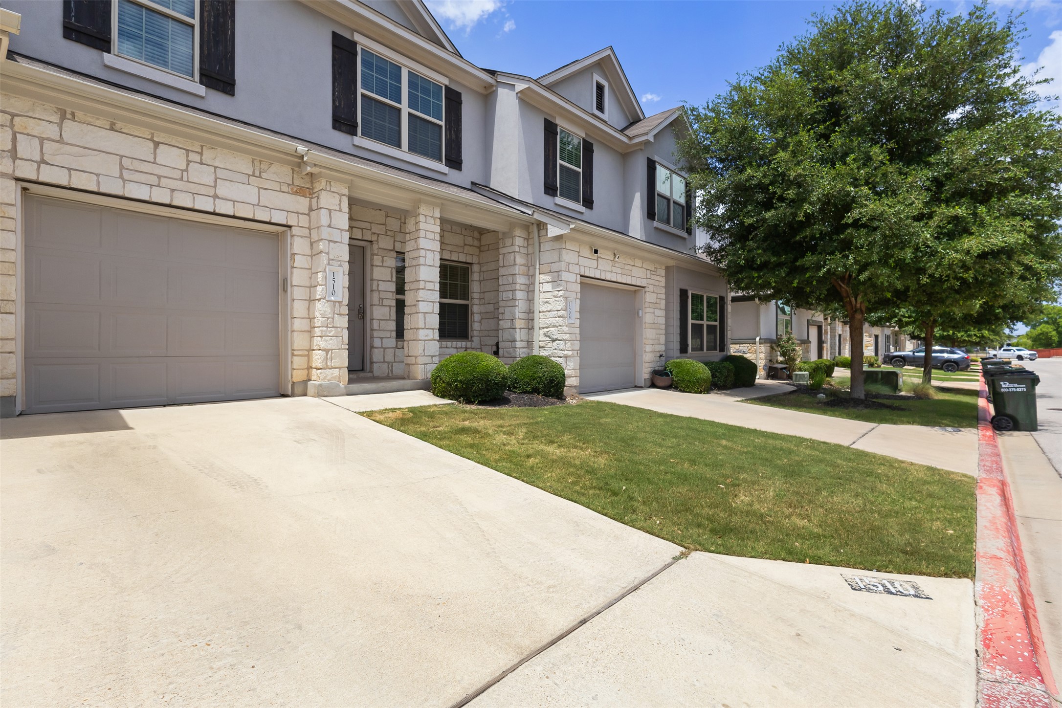 1510 Catalan Road, Unit 602 Austin, TX 78748 - Photo 3 of 36 View of property featuring stone siding, an attached garage, stucco siding, and concrete driveway