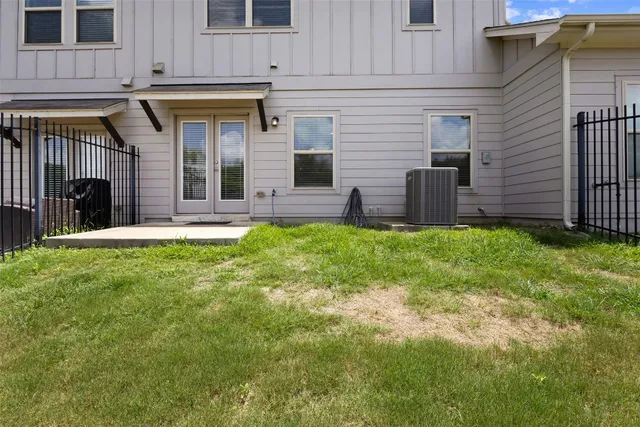 a view of a house with a yard and sitting area