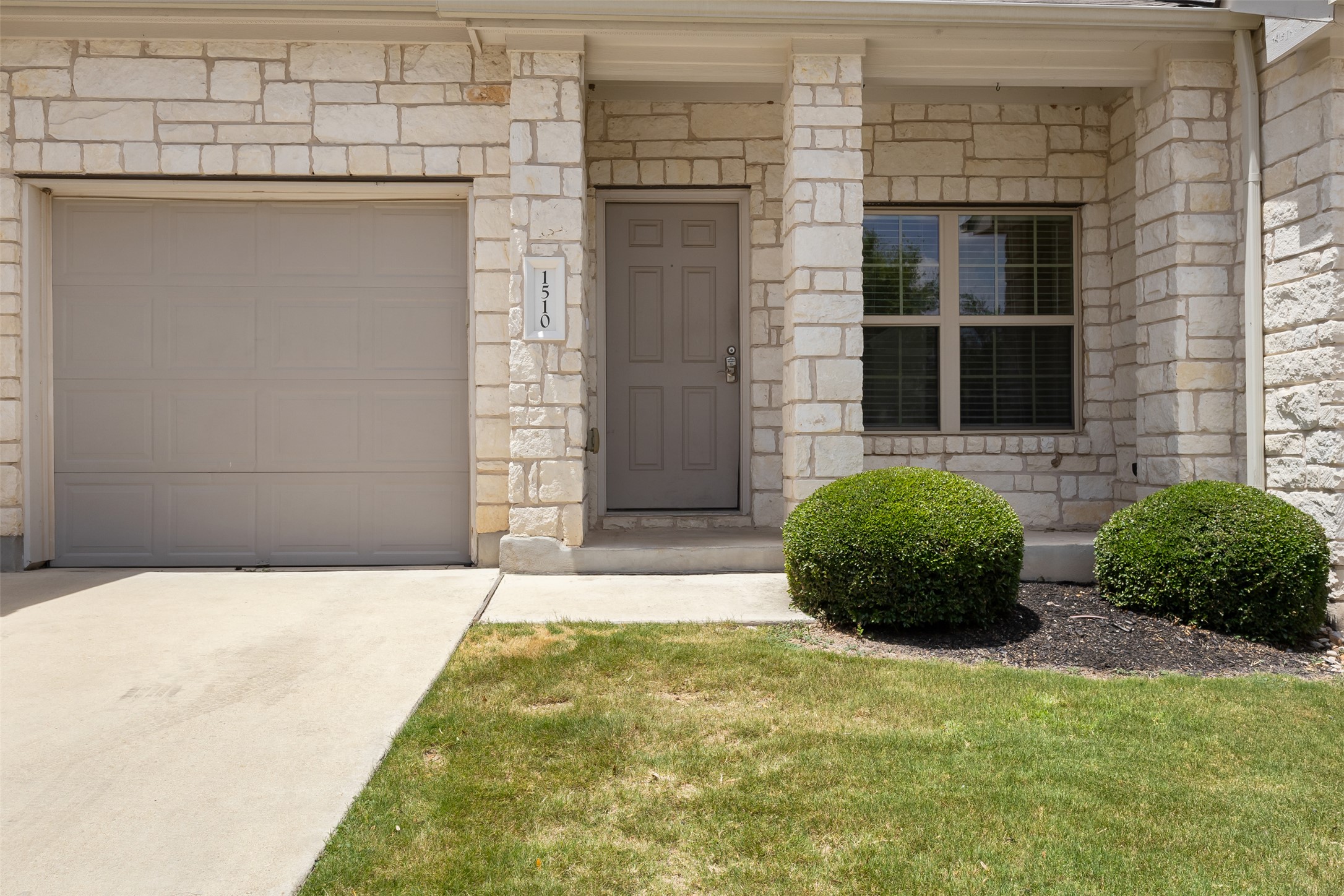 1510 Catalan Road, Unit 602 Austin, TX 78748 - Photo 4 of 36 Entrance to property with concrete driveway and stone siding