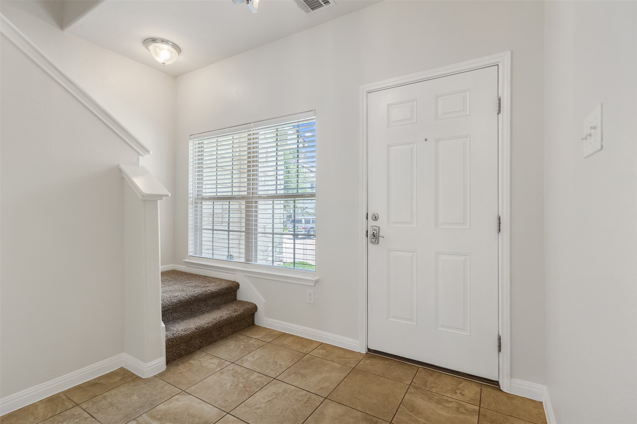 1510 Catalan Road, Unit 602 Austin, TX 78748 - Photo 5 of 36 Foyer featuring stairway, plenty of natural light, and light tile patterned floors