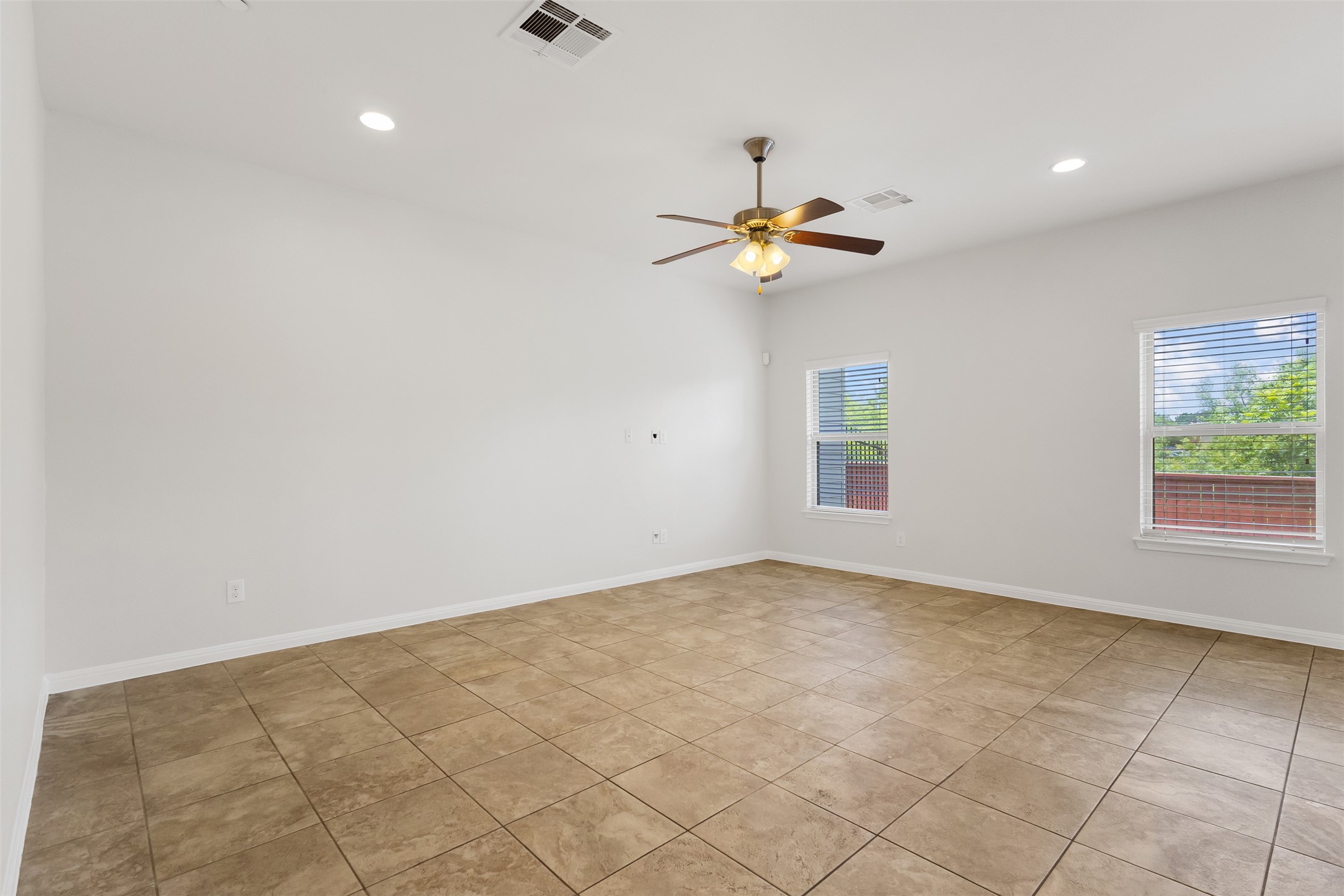 1510 Catalan Road, Unit 602 Austin, TX 78748 - Photo 7 of 36 Empty room with ceiling fan, light tile patterned flooring, and recessed lighting
