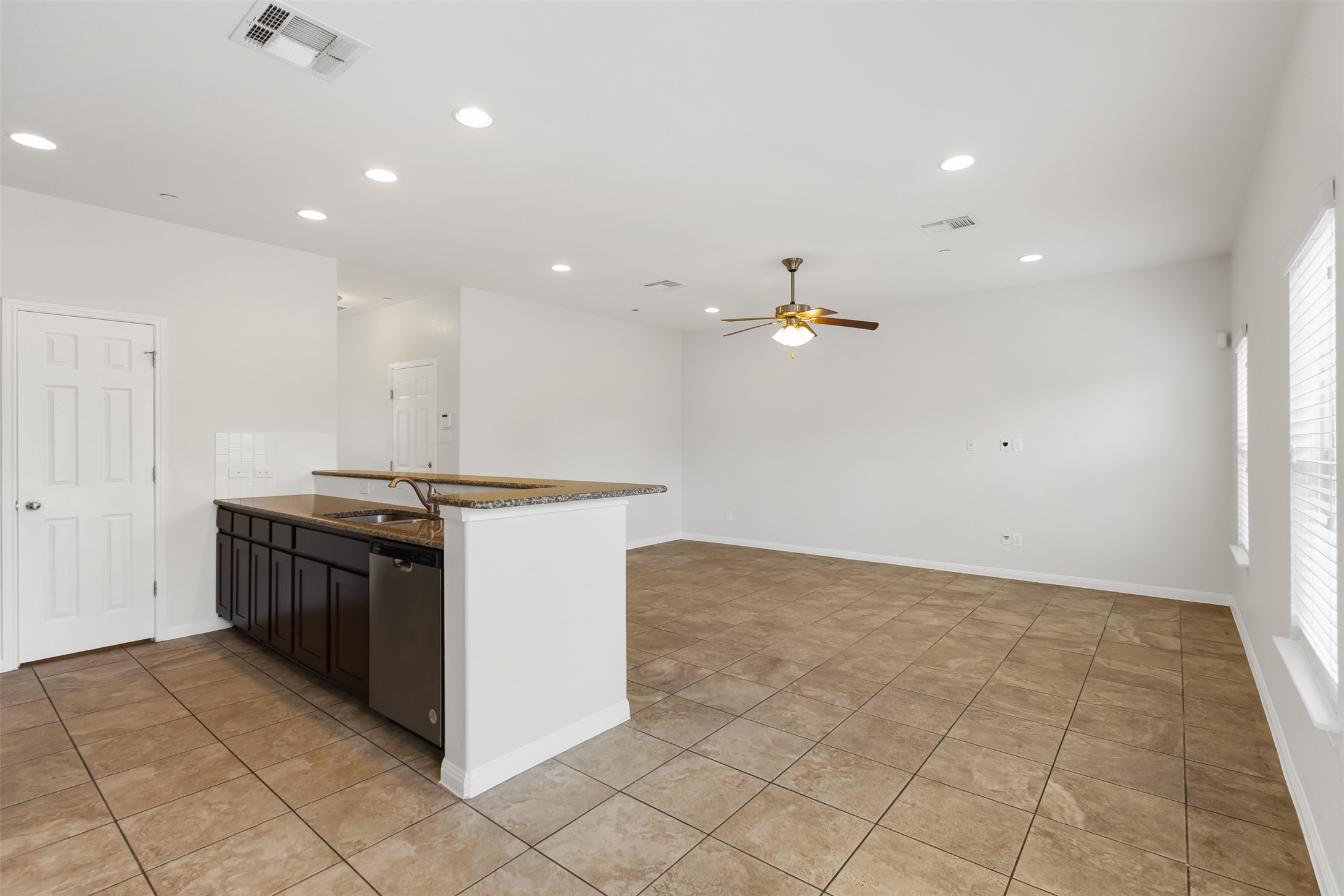 1510 Catalan Road, Unit 602 Austin, TX 78748 - Photo 10 of 36 Kitchen featuring stainless steel dishwasher, a ceiling fan, a peninsula, recessed lighting, and light tile patterned floors