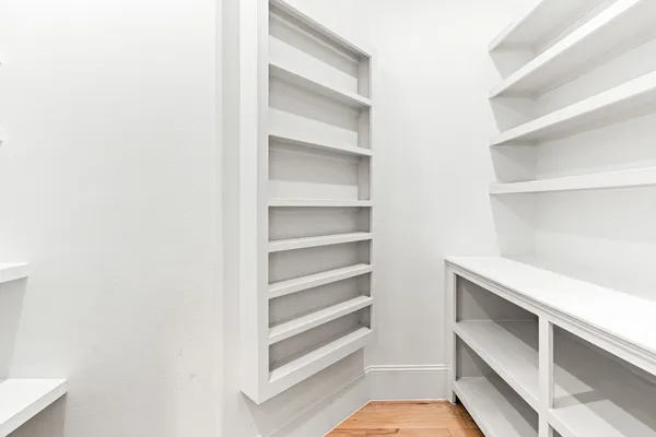 a hallway with a sink and a refrigerator