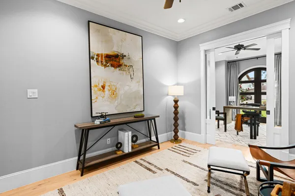 a living room with furniture and a painting on the wall