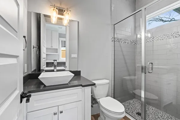 a view of hallway with sink and wooden floor