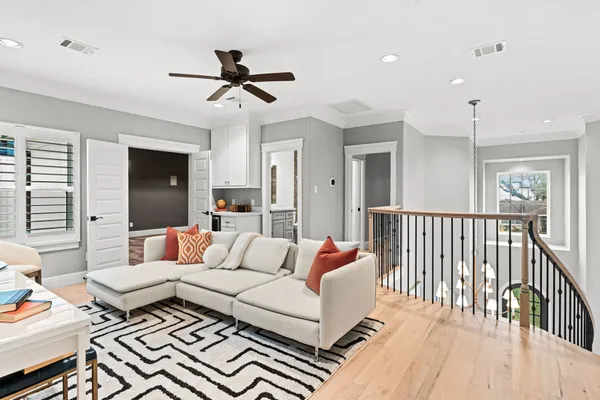 a living room with furniture a rug and a window