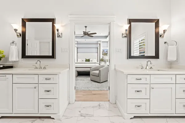 a spacious bathroom with a sink and a large mirror