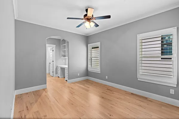 wooden floor in an empty room with a window