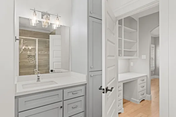 a bathroom with a double vanity sink a mirror and a shower