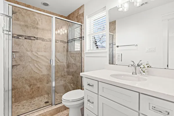 a bathroom with a sink toilet and shower