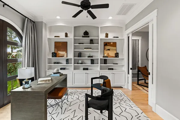 a living room with furniture cabinets and window