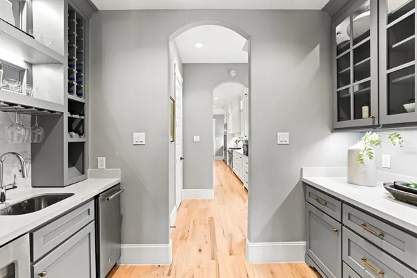 a kitchen with counter space appliances and wooden floor