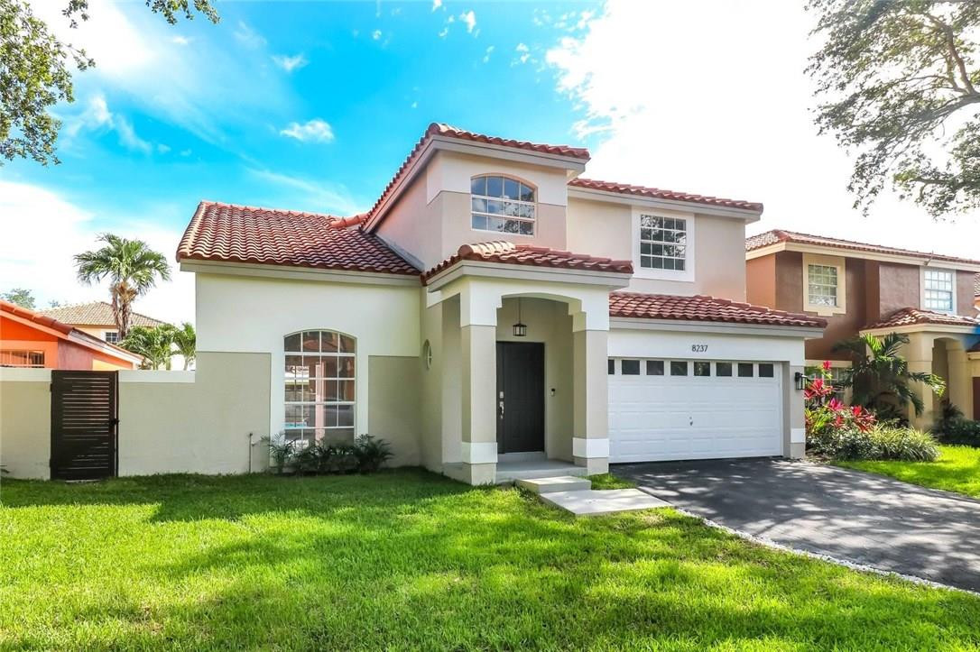 8237 Northwest 200th Terrace Hialeah, FL 33015 - Photo 1 of 30 a view of a house with a yard