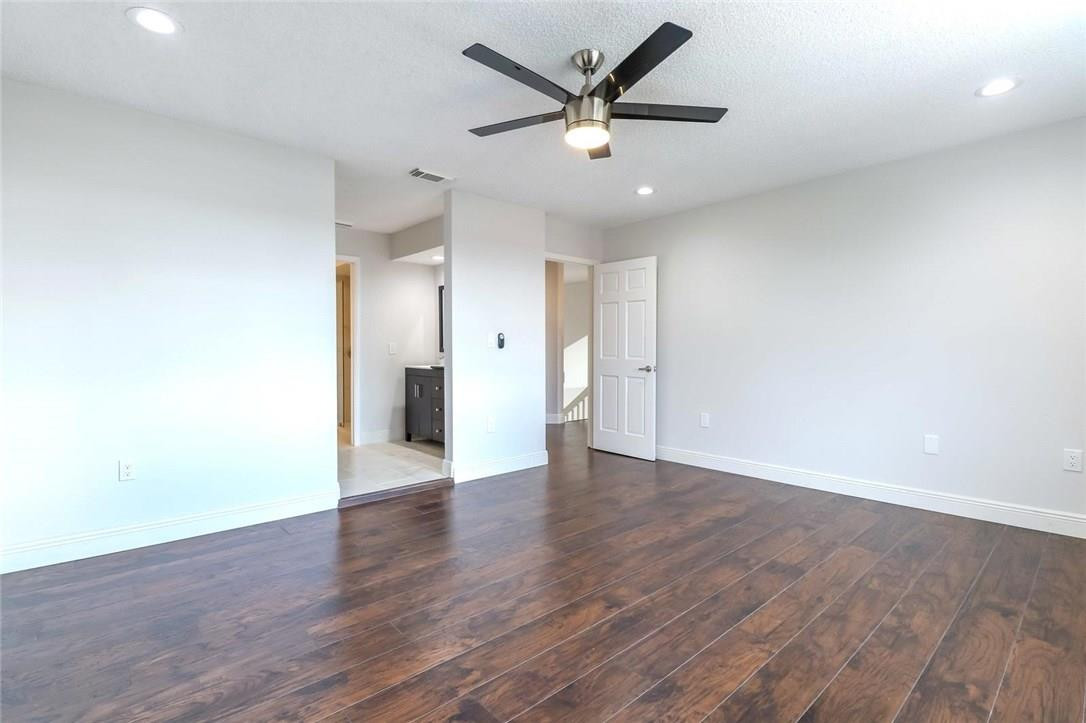 8237 Northwest 200th Terrace Hialeah, FL 33015 - Photo 15 of 30 an empty room with wooden floor and a ceiling fan