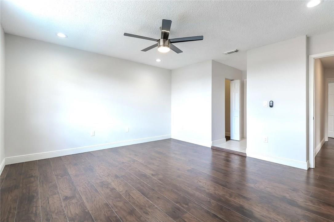 8237 Northwest 200th Terrace Hialeah, FL 33015 - Photo 16 of 30 an empty room with wooden floor and windows