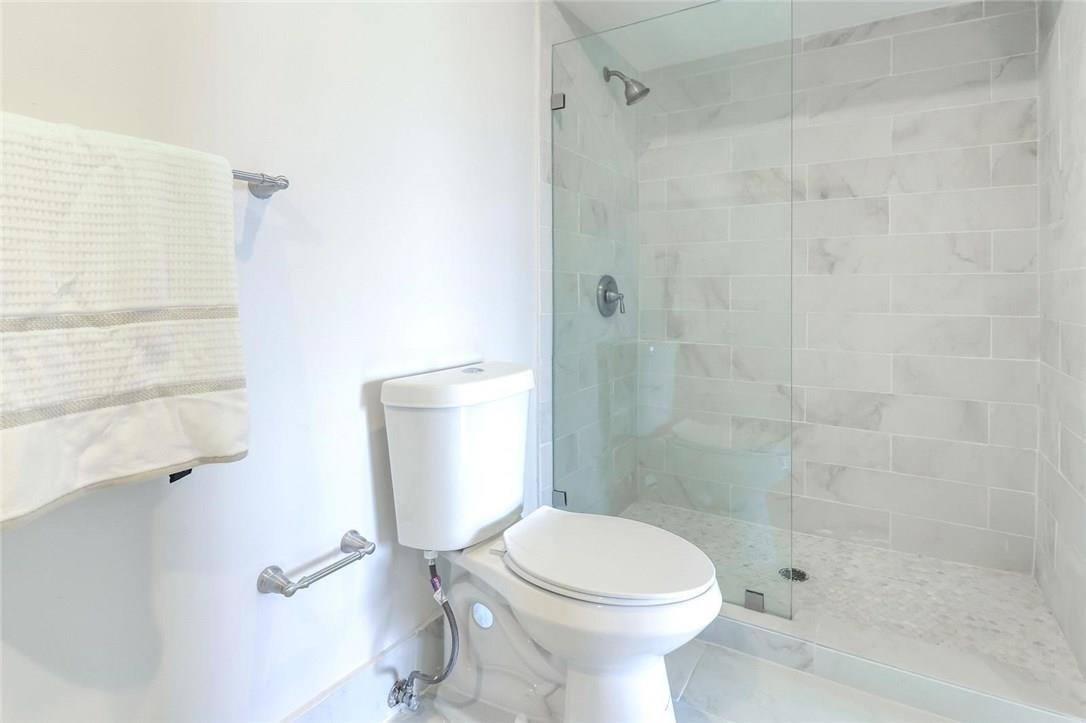 8237 Northwest 200th Terrace Hialeah, FL 33015 - Photo 18 of 30 a bathroom with a toilet a sink and shower