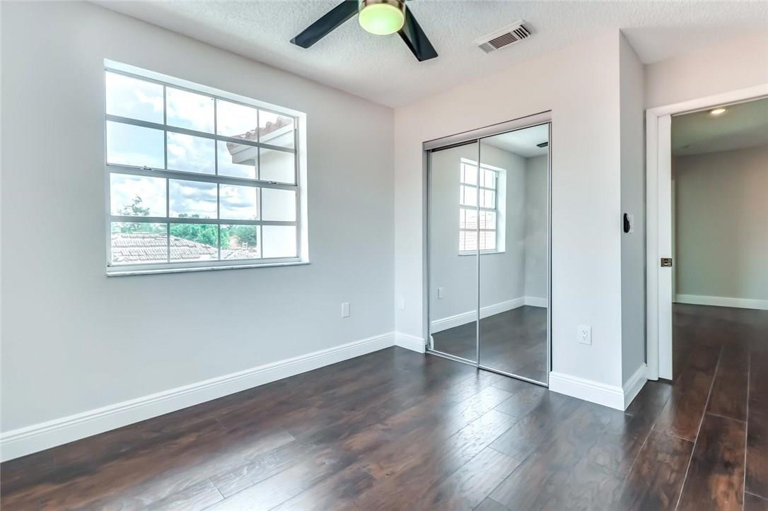 8237 Northwest 200th Terrace Hialeah, FL 33015 - Photo 20 of 30 an empty room with wooden floor and windows