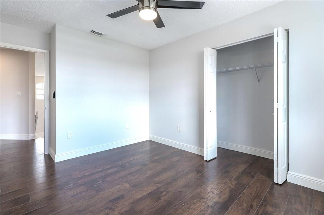 8237 Northwest 200th Terrace Hialeah, FL 33015 - Photo 23 of 30 an empty room with wooden floor and chandelier fan