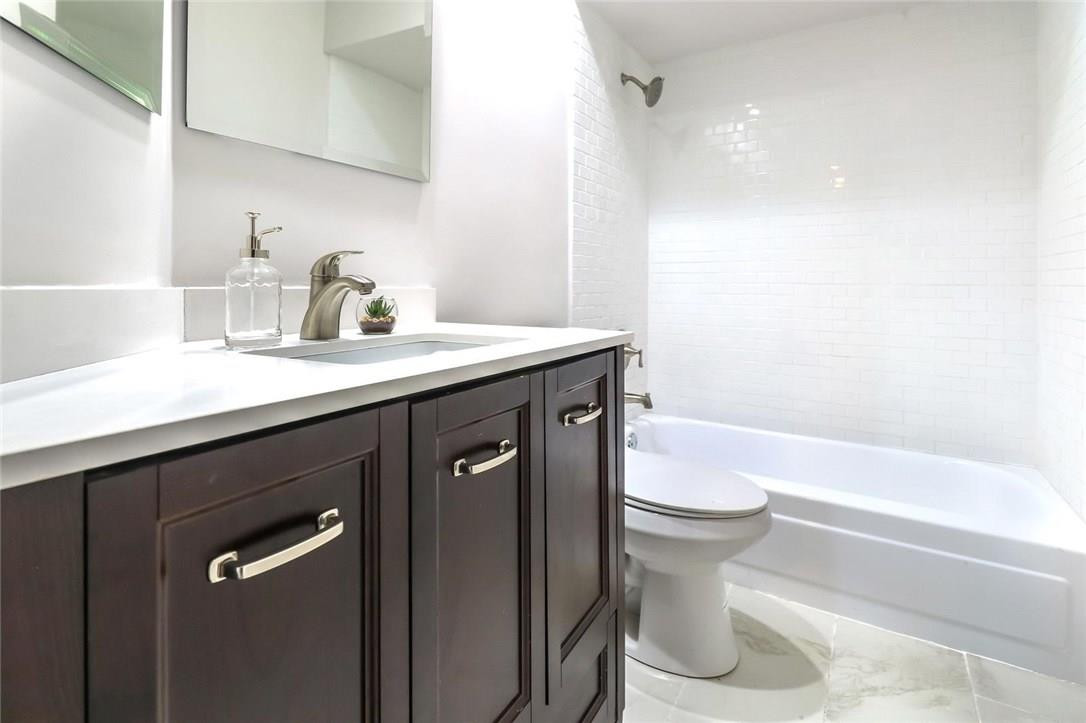 8237 Northwest 200th Terrace Hialeah, FL 33015 - Photo 26 of 30 a bathroom with a sink a toilet and shower