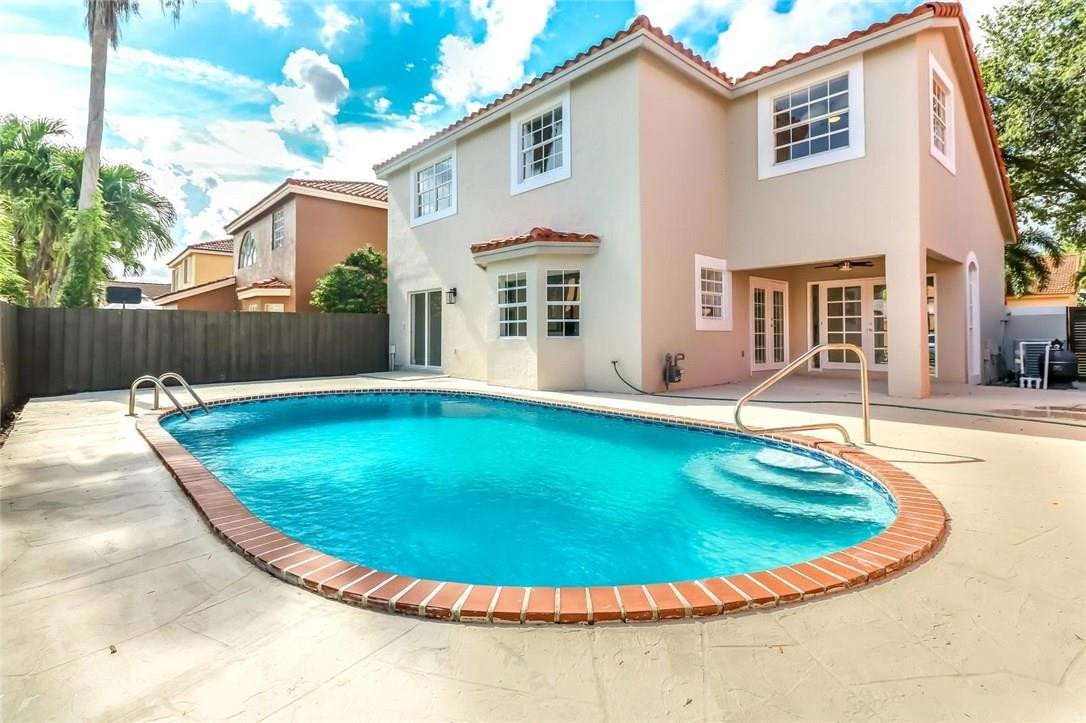 8237 Northwest 200th Terrace Hialeah, FL 33015 - Photo 28 of 30 a view of a house with swimming pool