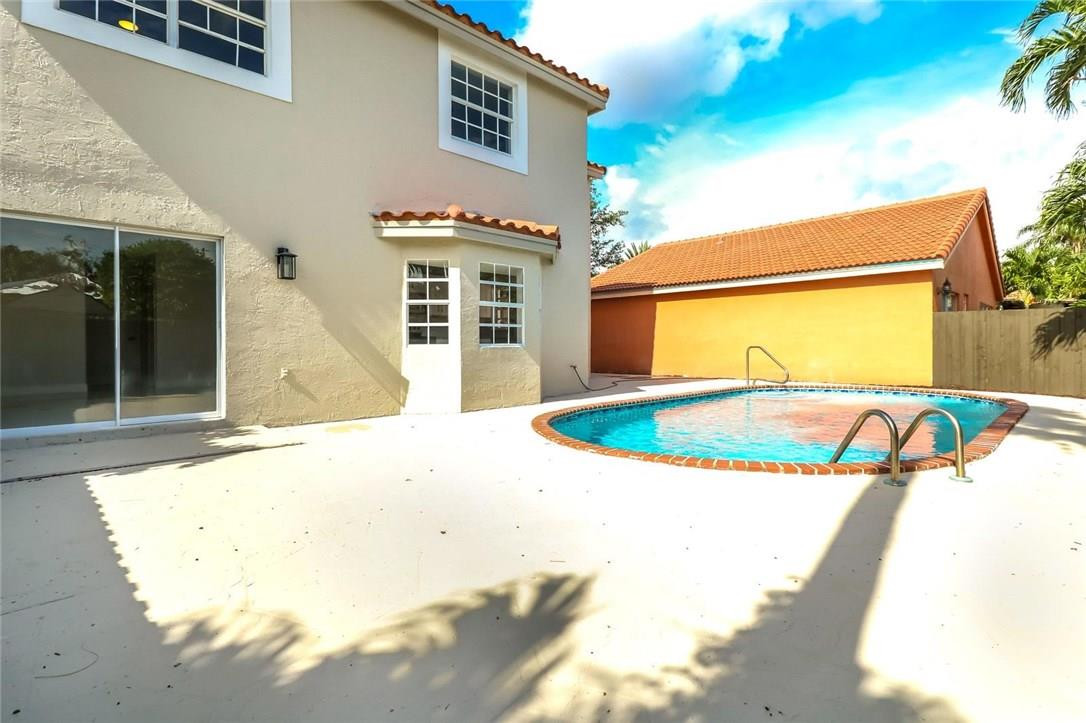 8237 Northwest 200th Terrace Hialeah, FL 33015 - Photo 29 of 30 a view of a house with a swimming pool