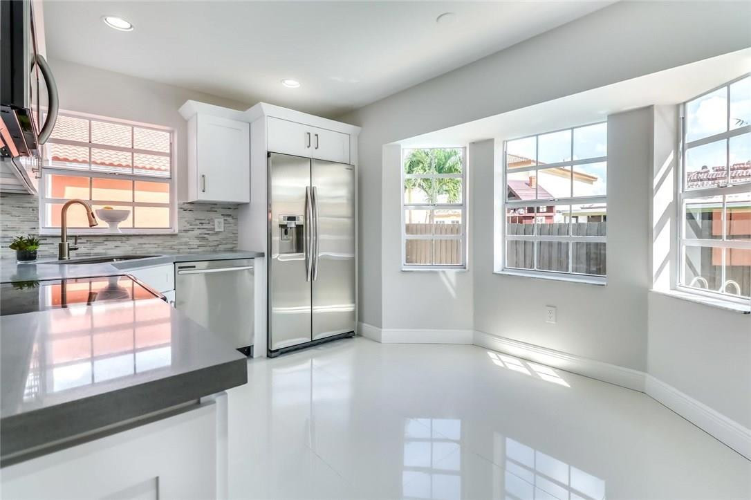 8237 Northwest 200th Terrace Hialeah, FL 33015 - Photo 9 of 30 a kitchen with stainless steel appliances a refrigerator and a sink