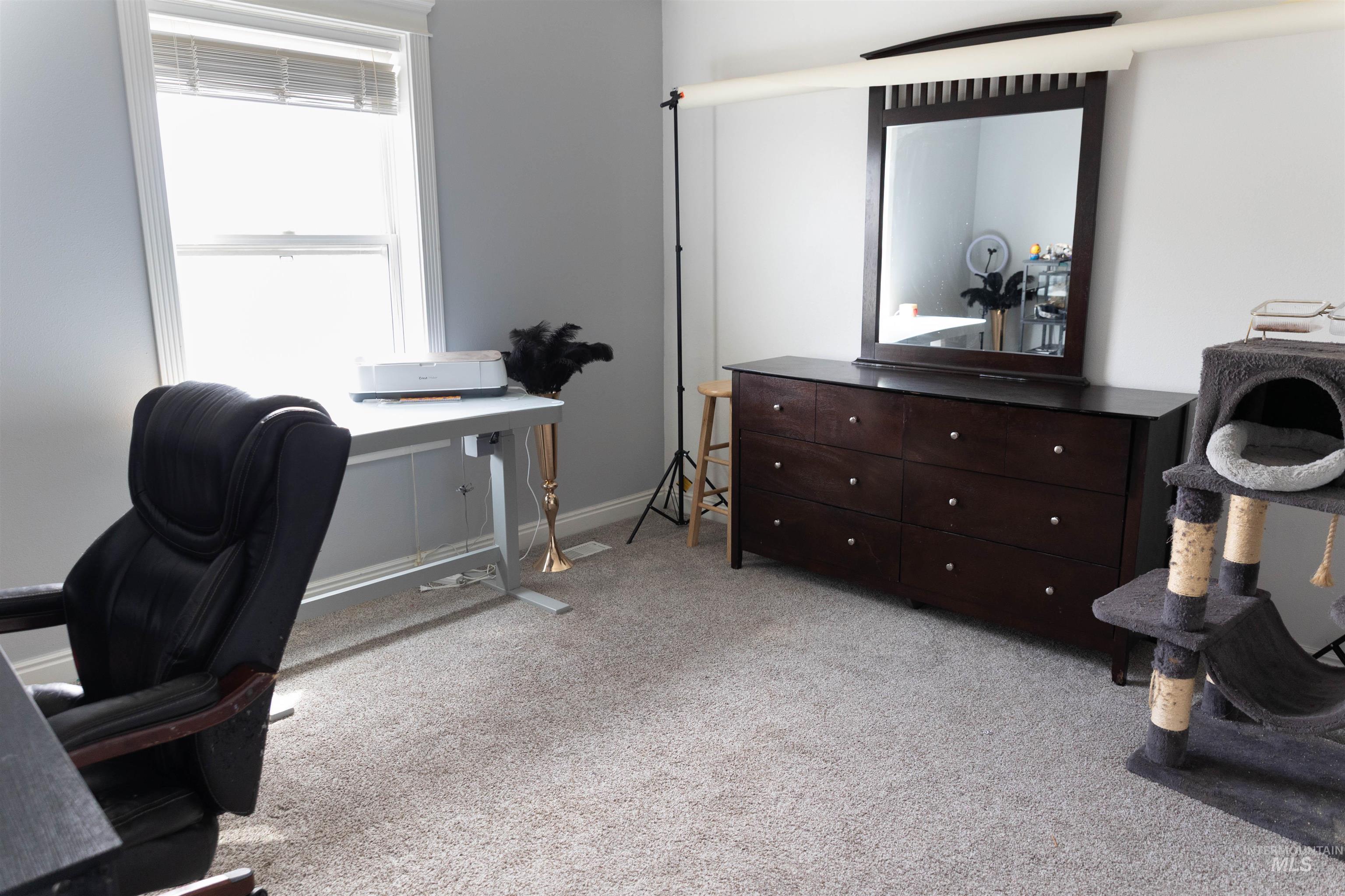 765 Southwest Foley Street Mountain Home, ID 83647 - Photo 14 of 37 Home office featuring light carpet and baseboards