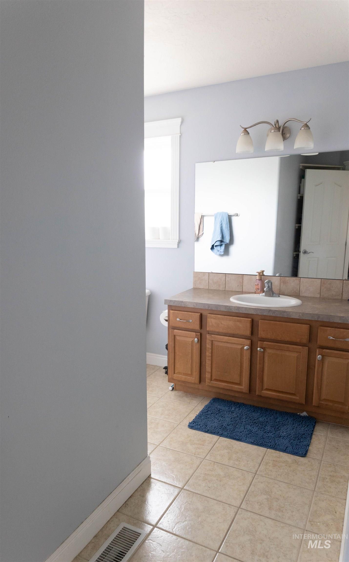 765 Southwest Foley Street Mountain Home, ID 83647 - Photo 17 of 37 Bathroom with light tile patterned flooring and vanity