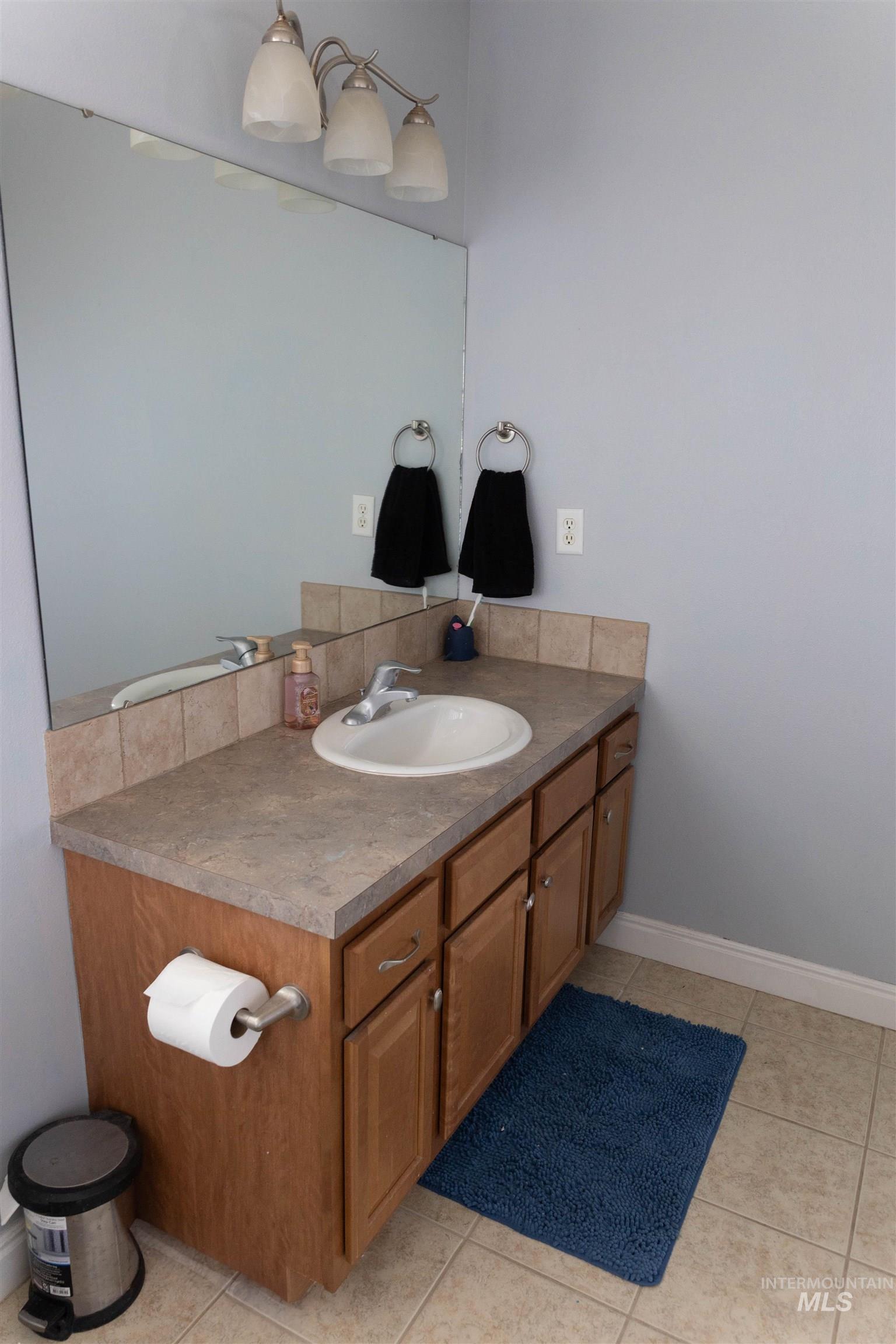 765 Southwest Foley Street Mountain Home, ID 83647 - Photo 19 of 37 Bathroom with vanity and light tile patterned flooring