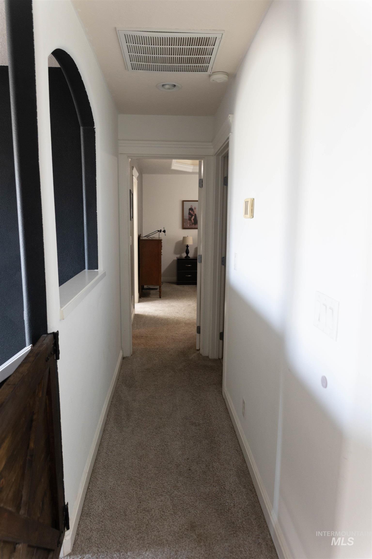 765 Southwest Foley Street Mountain Home, ID 83647 - Photo 20 of 37 Hallway featuring light carpet and baseboards
