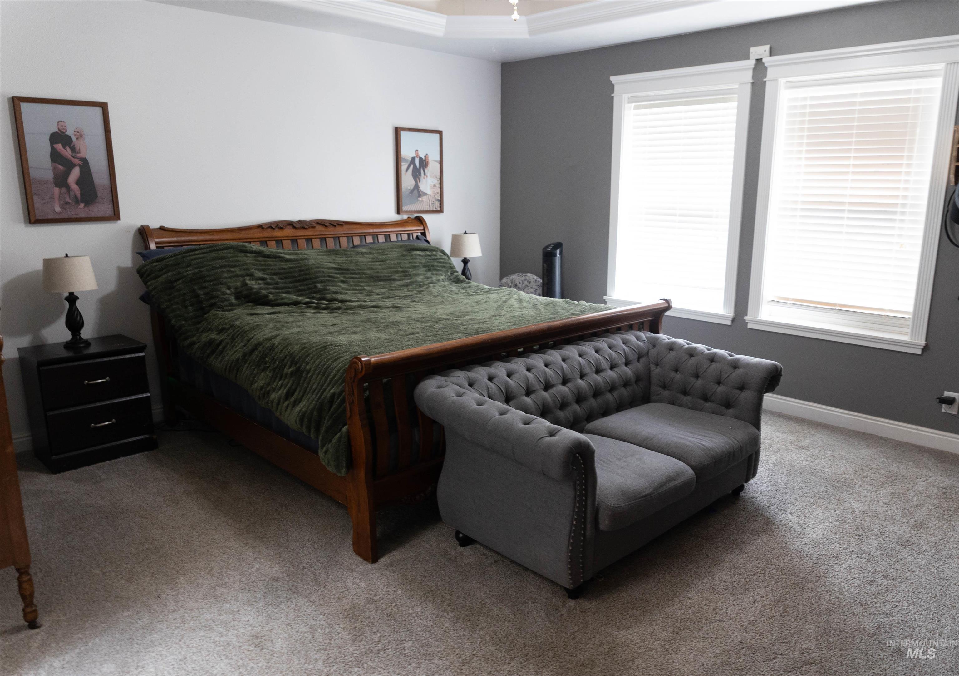 765 Southwest Foley Street Mountain Home, ID 83647 - Photo 21 of 37 Bedroom featuring carpet and a tray ceiling