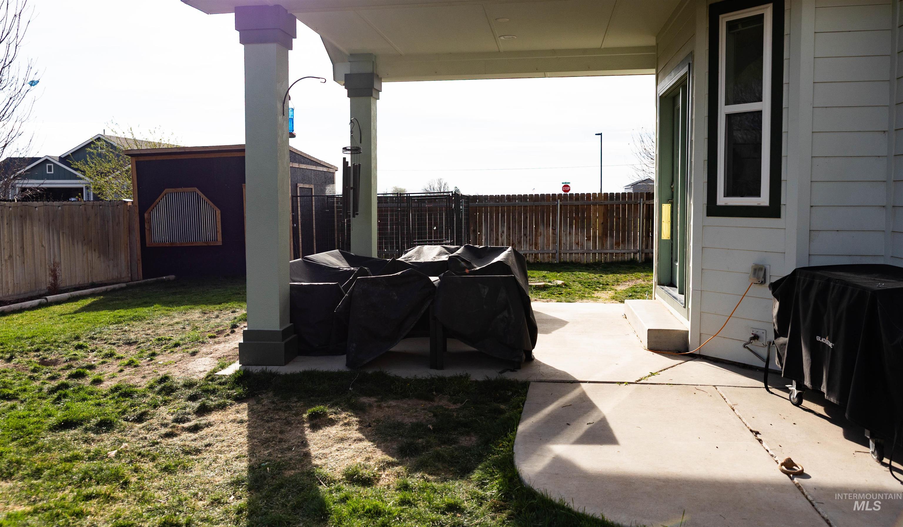 765 Southwest Foley Street Mountain Home, ID 83647 - Photo 28 of 37 Fenced backyard with a patio area and a grill