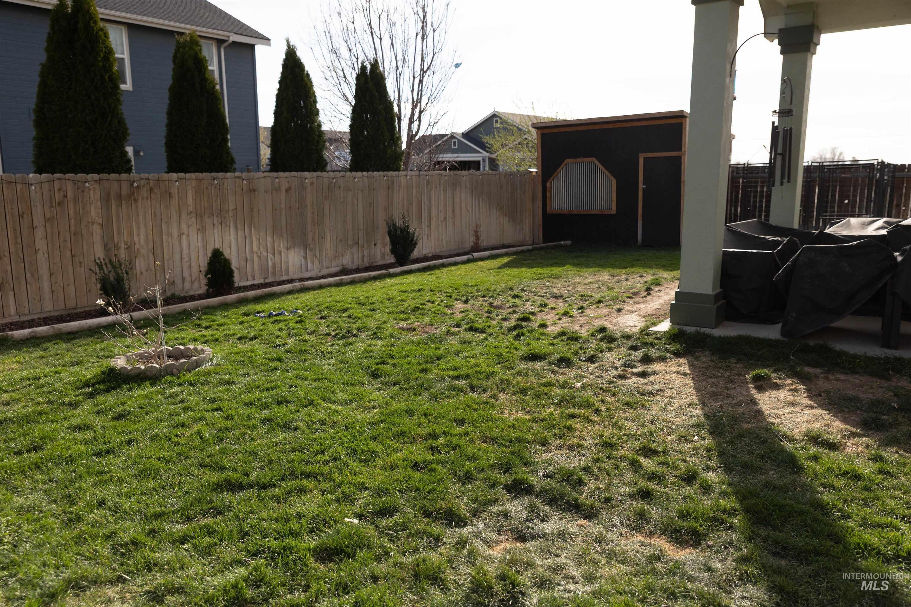 765 Southwest Foley Street Mountain Home, ID 83647 - Photo 29 of 37 Fenced backyard featuring an outbuilding and a patio