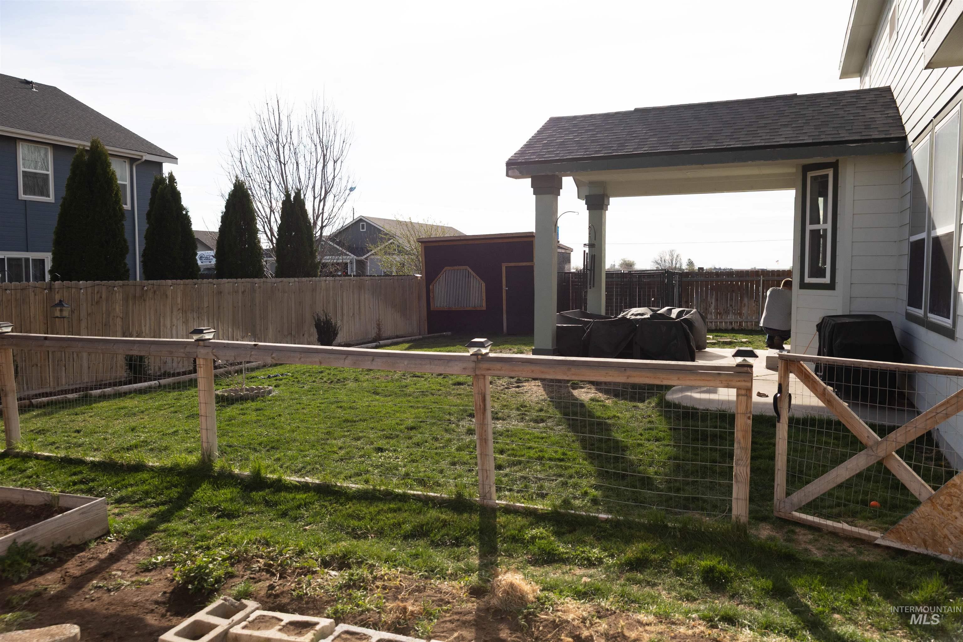 765 Southwest Foley Street Mountain Home, ID 83647 - Photo 32 of 37 Fenced backyard featuring a storage unit and a patio area
