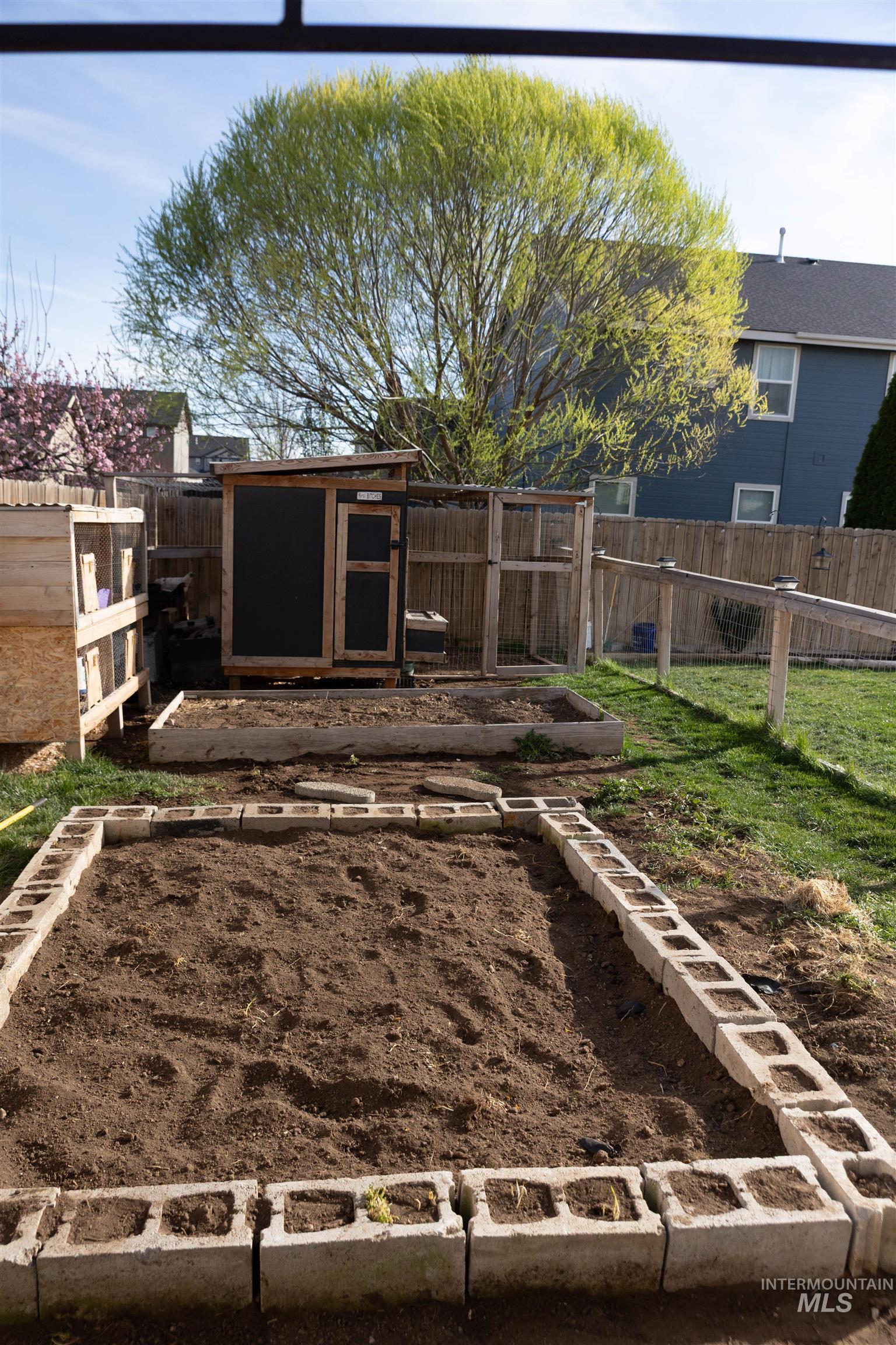 765 Southwest Foley Street Mountain Home, ID 83647 - Photo 33 of 37 Fenced backyard with an outbuilding and a vegetable garden