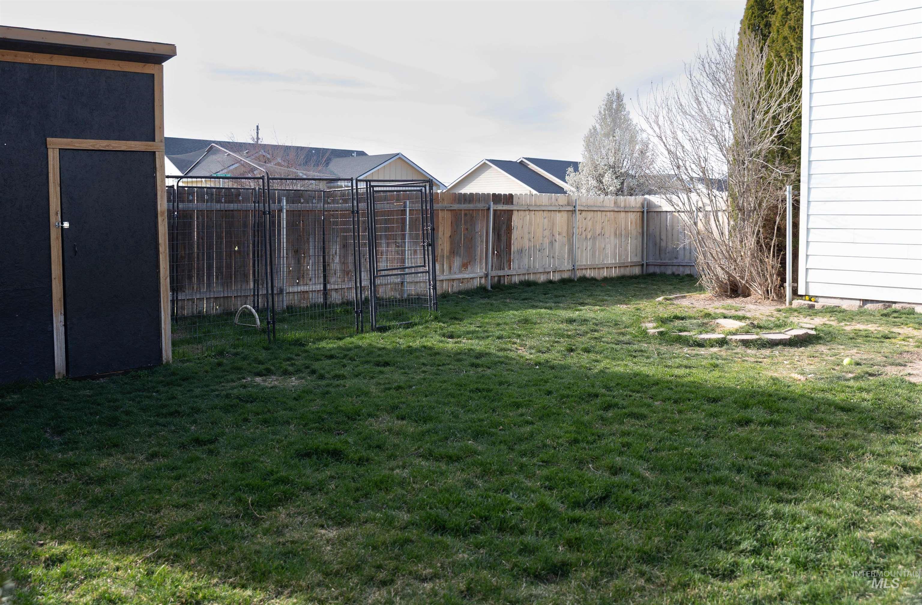 765 Southwest Foley Street Mountain Home, ID 83647 - Photo 36 of 37 Fenced backyard with an outdoor structure