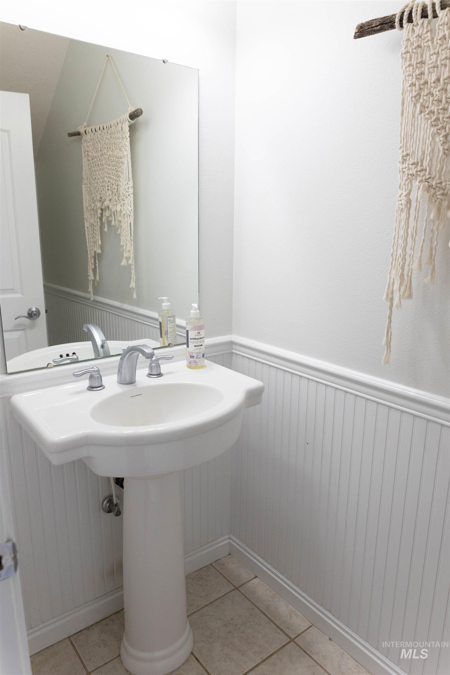 765 Southwest Foley Street Mountain Home, ID 83647 - Photo 8 of 37 Bathroom featuring a wainscoted wall and light tile patterned flooring