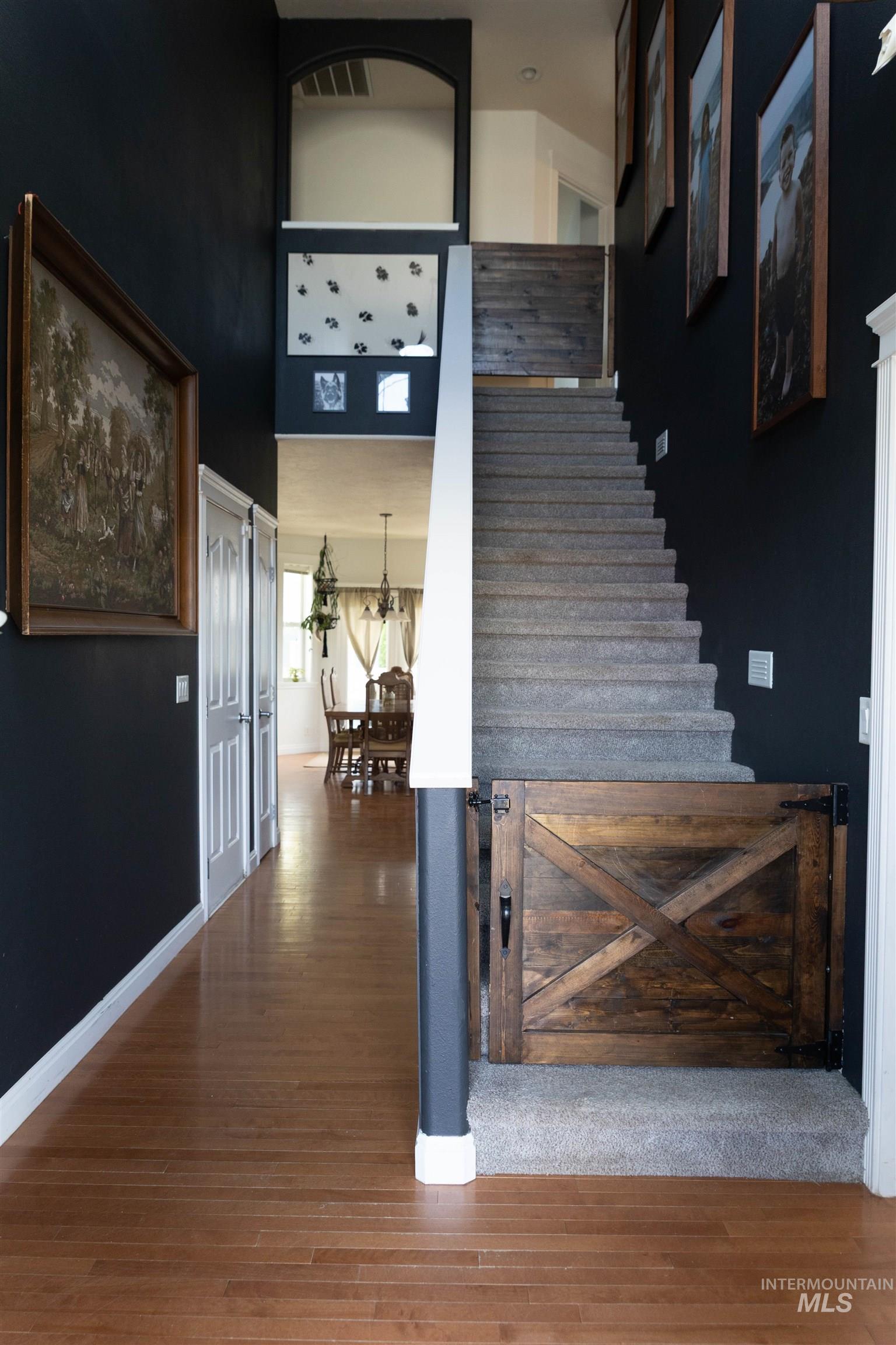 765 Southwest Foley Street Mountain Home, ID 83647 - Photo 10 of 37 Stairway featuring a high ceiling and wood finished floors