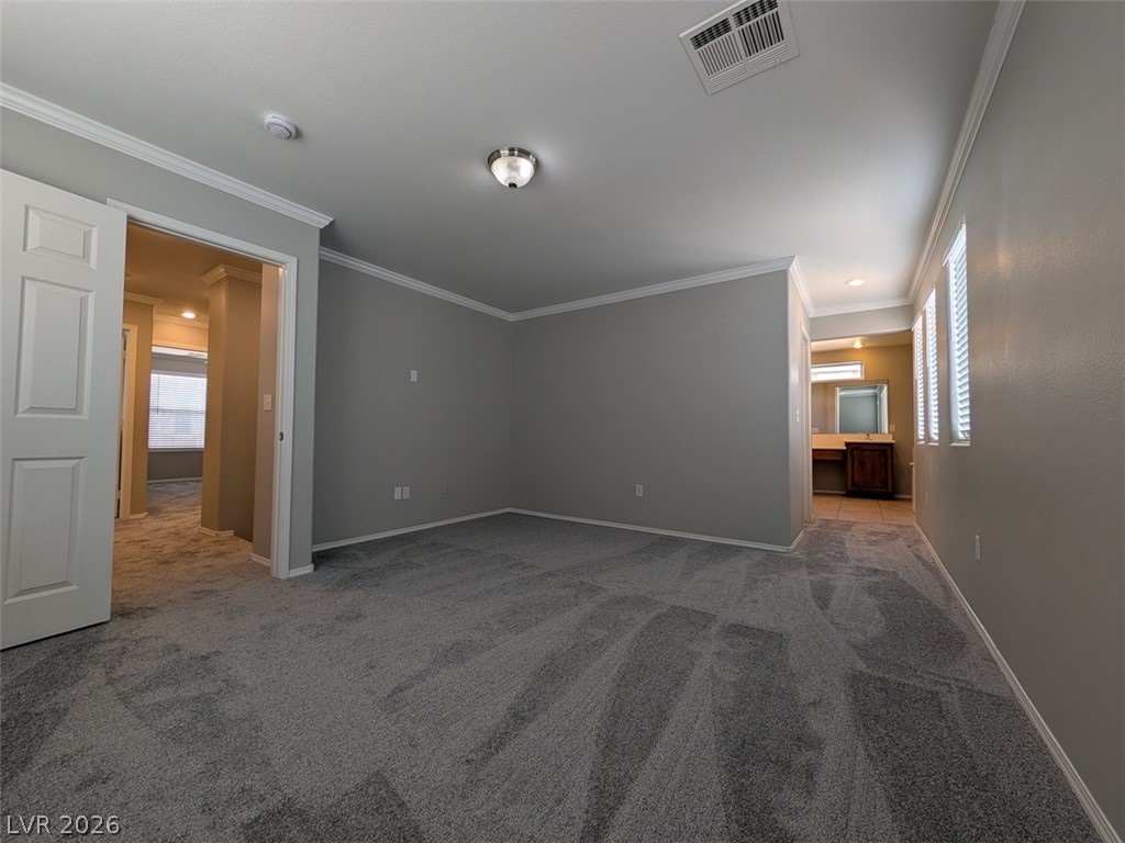 10308 Faustine Avenue Las Vegas, NV 89129 - Photo 10 of 28 Step into comfort with plush carpet and architectural trim creating an inviting living space.