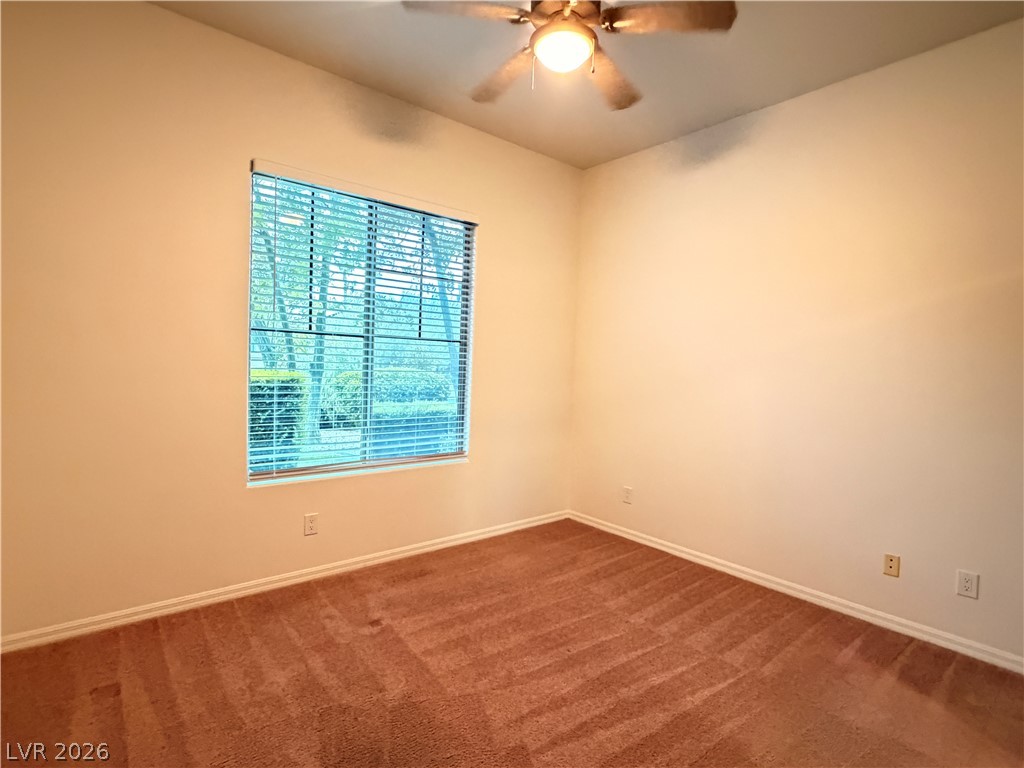 16 Caprington Road Henderson, NV 89052 - Photo 13 of 16 Plush carpeting anchors this versatile room under high ceilings and a wide window.